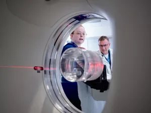 Patricia Byrne, CT Technologist, and John Seccareccio, Director Imaging Services, setting up CT scanner.