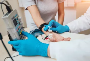 Patient nerves testing using electromyography (EMG) by doctor during an appointment.